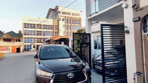 A Toyota SUV parked in a gated driveway with a building labeled "Toyo Medical Center" in the background.
