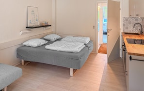 A bedroom with a bed, bedside table, and a view of the outside. - Awesome apartment in Nexø with WiFi (Nexø)