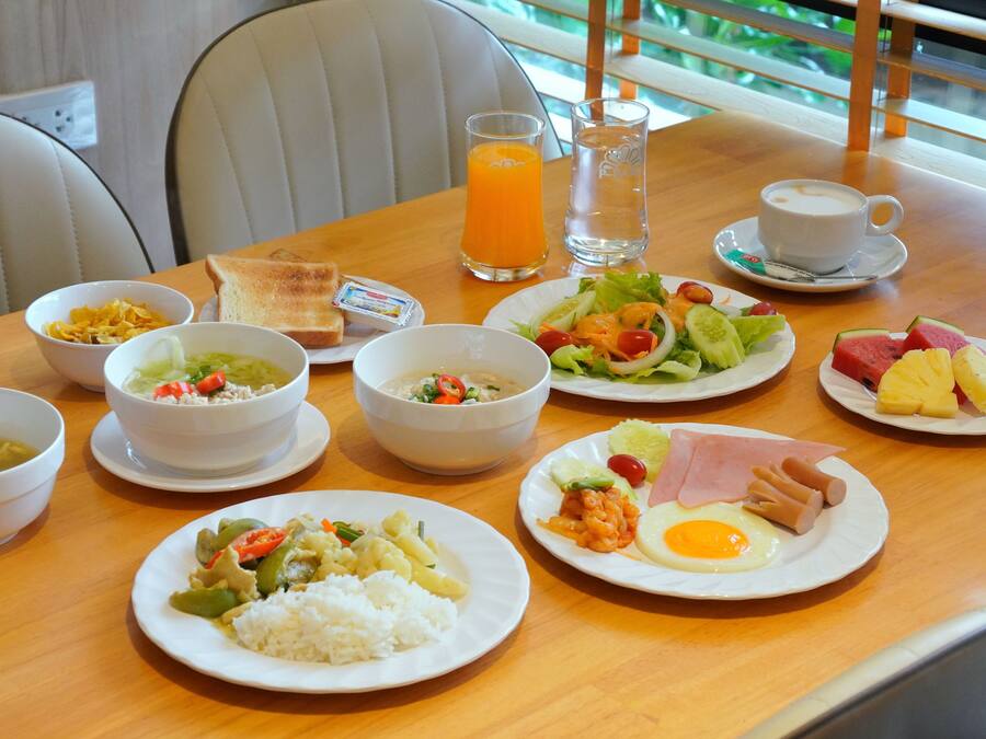 A dining table with various dishes including rice, soup, and a salad.