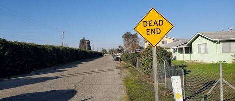 A residential street with a 'DEAD END' sign.