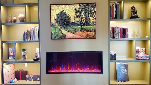 A living room with a fireplace, bookshelves, and a framed painting. - Home Among the Orchards, Pool, National Parks, Friendliest of Towns (Exeter)