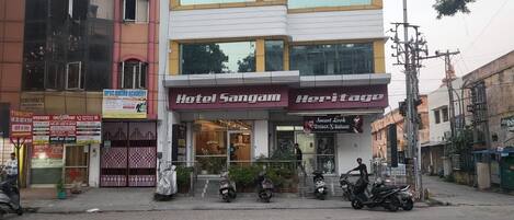 A multi-story building with a ground-level entrance for Hotel Sangam and Heritage.