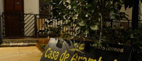 A sign for Casa de Arambol with contact information and an email address.