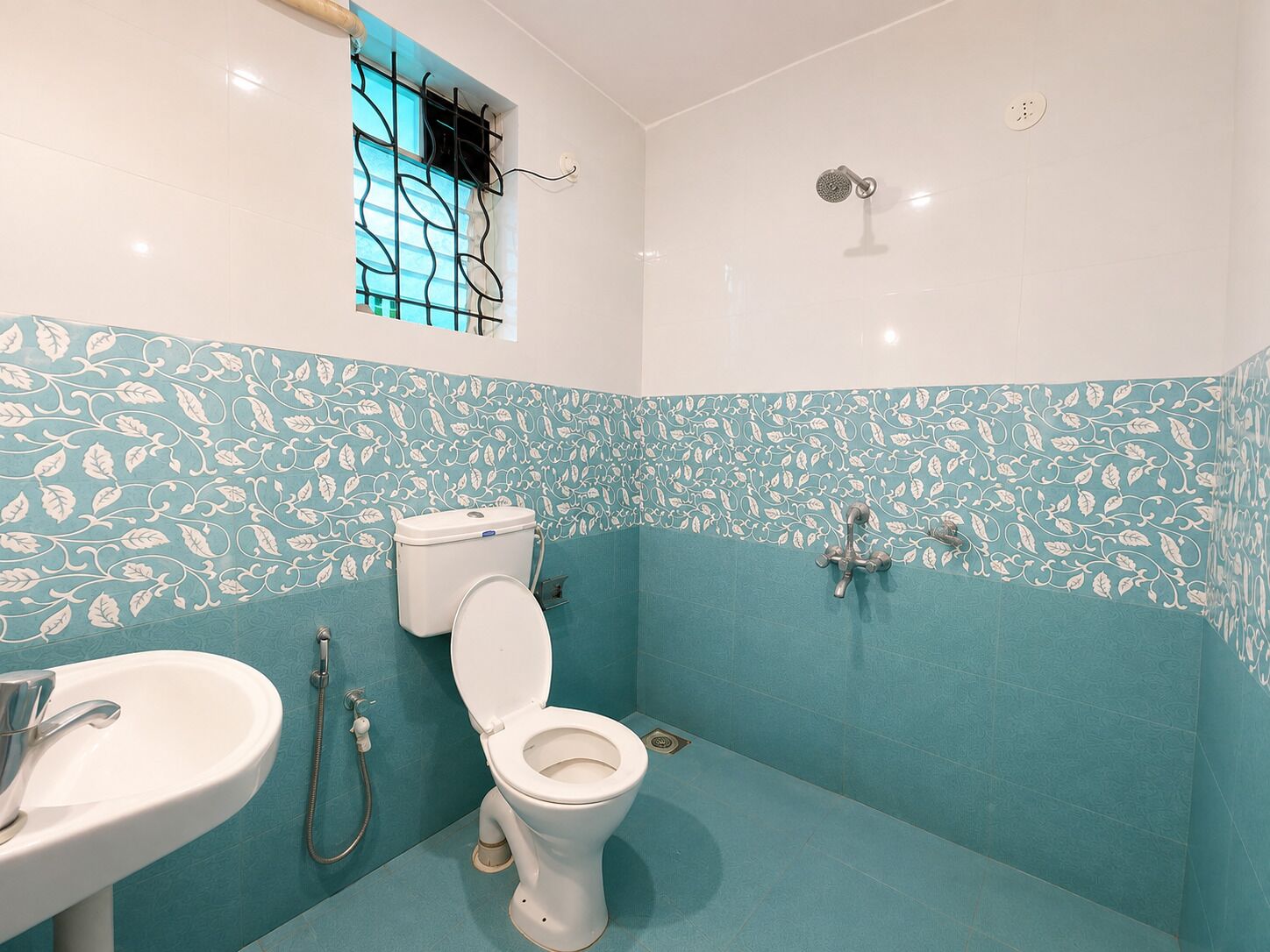 A bathroom with a toilet, sink, and shower.