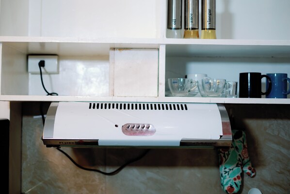 A kitchen with a white countertop, a Fujidenza appliance, and various kitchenware. - Rb's Three Storey House (Zamboanga)