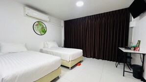Ein Hotelzimmer mit zwei Betten, einer Klimaanlage, einem Schreibtisch mit Stuhl, einem Fernseher und einem Vorhang.