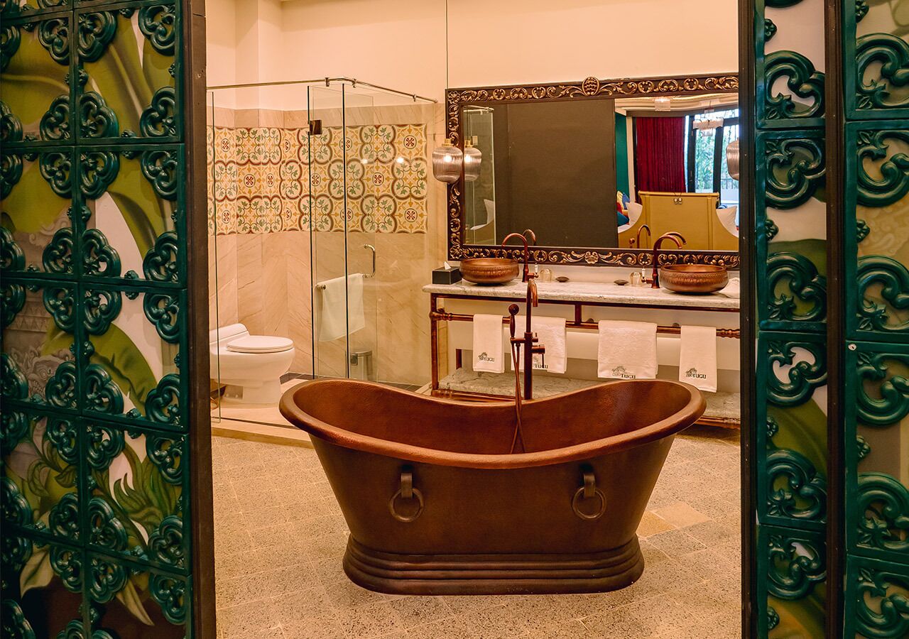 A bathroom with a freestanding bathtub, a glass shower enclosure, and a vanity with a large mirror.