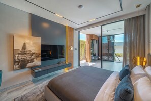 A modern bedroom with a large bed, a flat-screen TV, a painting, and a sliding glass door leading to a balcony. - Beyond The Palms (Canggu)