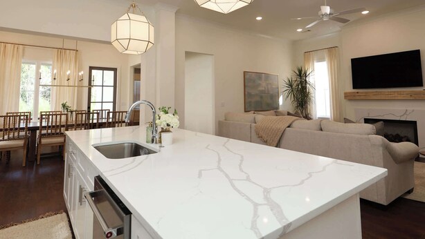 A spacious kitchen with a large island, pendant lights, and a ceiling fan. - Magnolia Manor by Apex Short Term Stays (Oxford)
