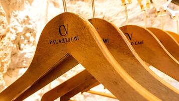 Wooden hangers with the text "PALAZZO CAVI" hanging on a rack.