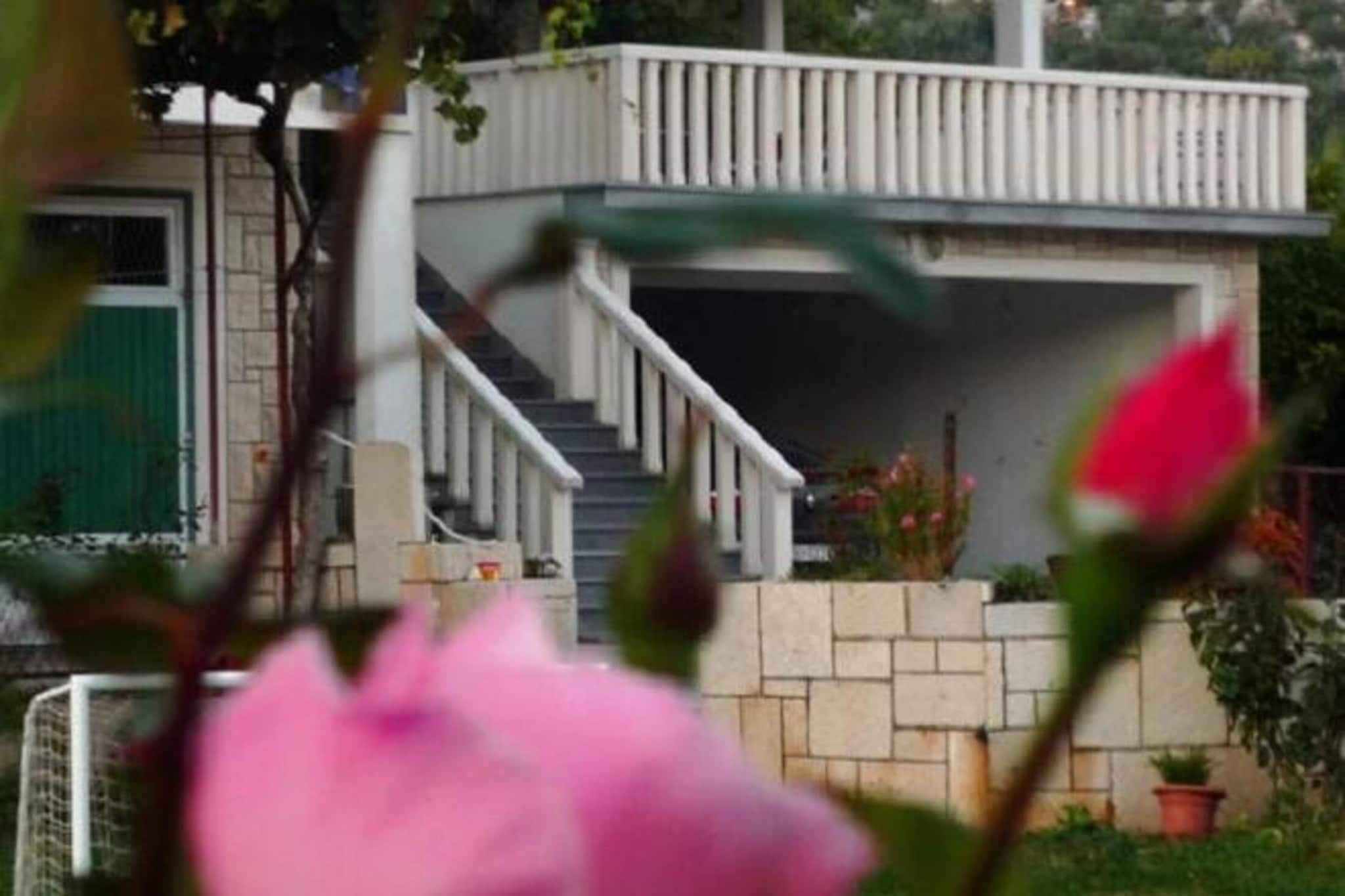 A residential building with a staircase leading to a balcony.