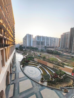 A high-rise building with a curved pathway and landscaped areas. - Arth Corporate Suites at Gomti Nagar Ext (Lucknow)