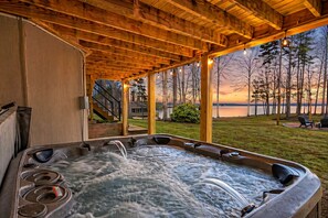 A hot tub under a wooden pergola with a view of a lake and trees at sunset. - Luxurious 8-Bed Lakefront Retreat with Private Beach, Hot Tub & Sauna! (Bumpass)
