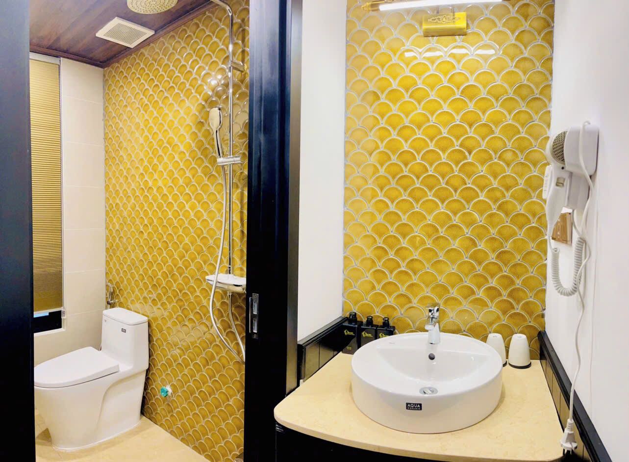 A bathroom with a toilet, a sink, and a shower.