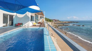 A swimming pool with a view of the ocean and a beach. - Yeongdeok Chaeumneul Poolvilla (Yeongdeok)