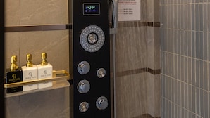 A modern shower with a digital control panel, a water jet feature, and a sign with usage instructions. - Phuc Hai Hotel Da Lat (Lang Biang - Da Lat)
