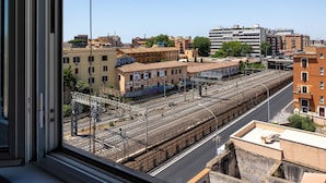 A view of a train station with multiple tracks and surrounding buildings. - Via Casilina 161 in Rome (Rome)