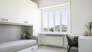 A modern bedroom with a built-in bed, a desk, and a window with a city view. - Via Casilina 161 in Rome (Rome)