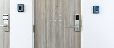 Una puerta moderna con teclado electrónico y lector de tarjetas, que indica un sistema de acceso seguro.