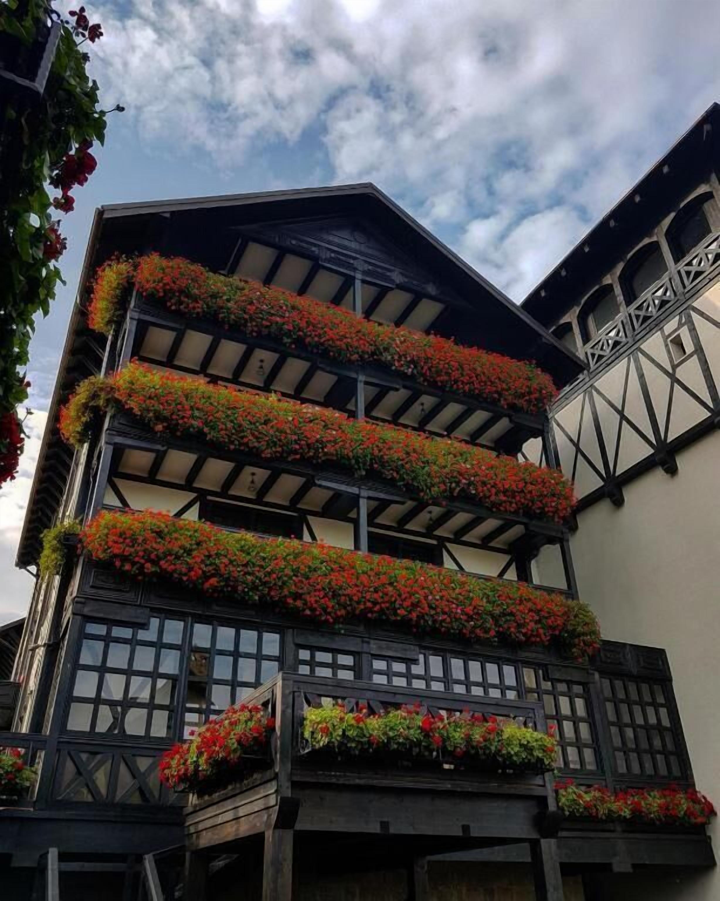 A traditional building with multiple balconies adorned with flower boxes.