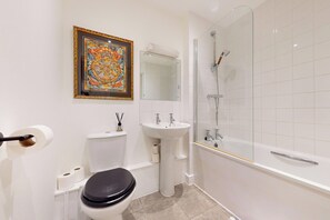 Shower, hair dryer, towels, toilet paper