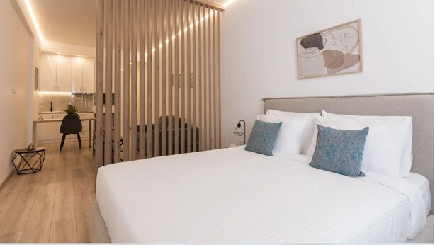 A modern hotel room with a large bed, a desk, and a sliding partition. - Athens Syntagma Ermou (Athens)