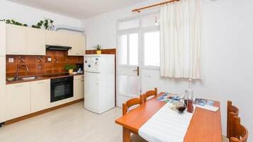 Fridge, oven, stovetop, dining tables