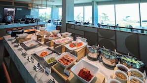 A buffet with various food items and a view of the outdoors. - HAENAM 126 HOTEL (Haenam)