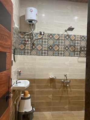 A bathroom with a shower, a sink, and a toilet.