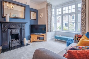 Traditional House | Living area | 32-inch flat-screen TV with cable channels - Overland Road 4 Bed House Mumbles (Swansea)