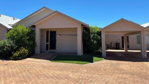 A row of two-story houses with a paved driveway and a small lawn area. - Pelican Shore Villa 20 - Kalbarri WA (Kalbarri)