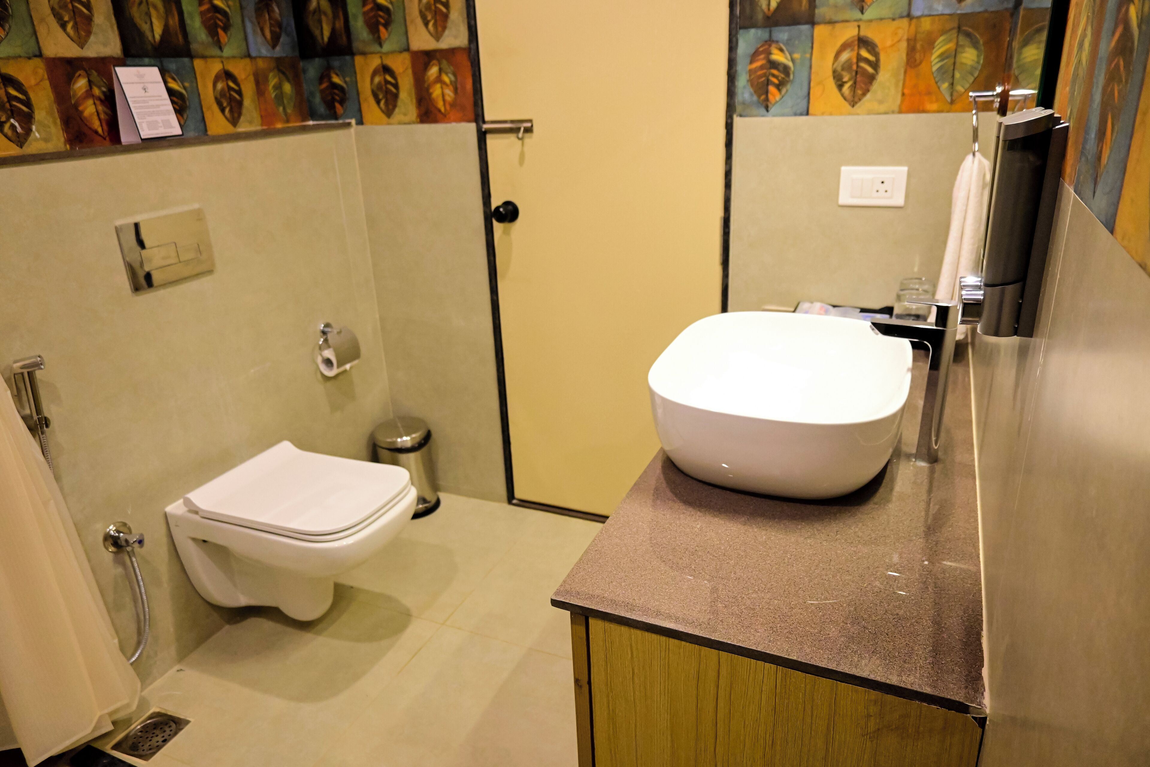 A bathroom with a toilet, a sink, and a shower.