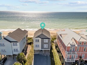 A beachfront property with multiple houses, a clear view of the ocean, and a turquoise location marker. - In Spiaggia (at the beach) #185 - 6 BD Oceanfront in the heart of Surf City! (Surf City)