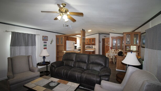 A living room with a sofa, armchairs, a coffee table, and a ceiling fan. - 334 N Harbor - Perfect Place to getaway & relax! (Port Mansfield)