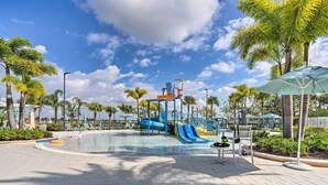 A water park with a blue slide and a water play area. - 15 Mi to Wdw: Retreat w/ Private Pool! (Kissimmee)