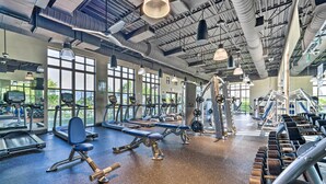 A gym with various exercise equipment, large windows, and a high ceiling with visible ductwork. - 15 Mi to Wdw: Retreat w/ Private Pool! (Kissimmee)