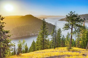 A mountainous landscape with a lake, surrounded by dense forests and clear skies. - 1 Mi to Tubbs Hill & Lake: Midtown Home w/ Yard! (Coeur d'Alene)