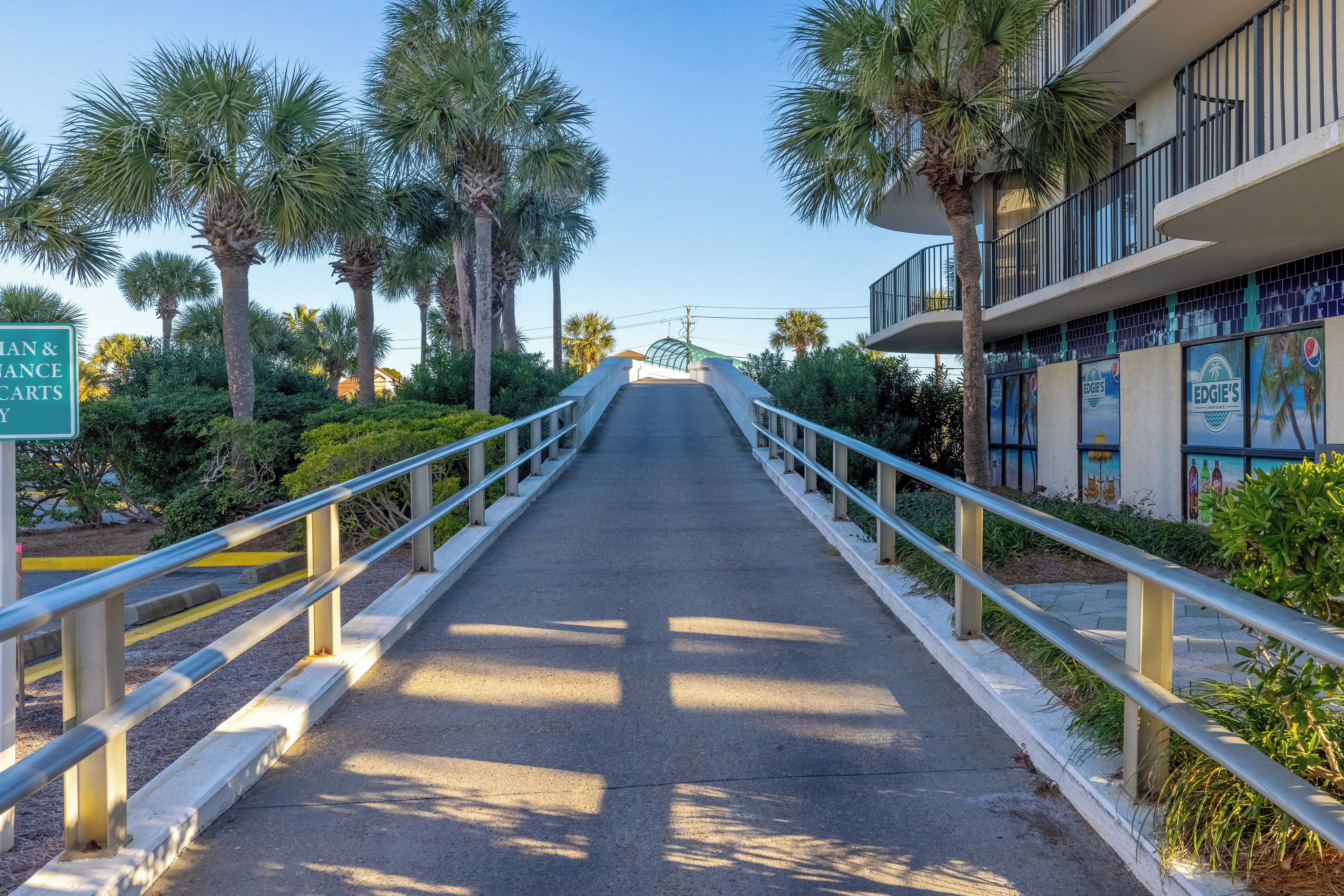A pathway leading to a building with a sign for 'Man's Lounge & Carts'.