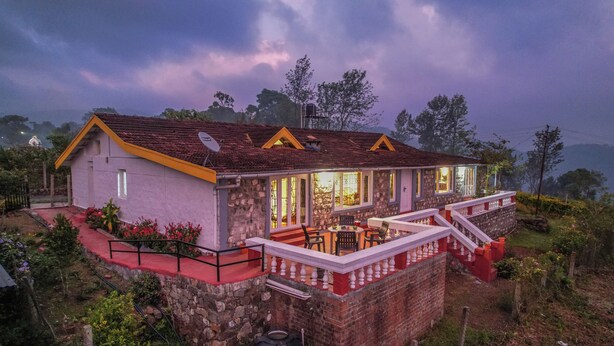 A stone house with a yellow roof, a balcony with white balustrades, and a satellite dish. - Rico Retreat (Kotagiri)