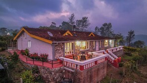 A stone house with a yellow roof, a balcony with white balustrades, and a satellite dish. - Rico Retreat (Kotagiri)