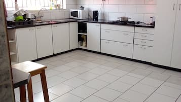 Full-size fridge, microwave, stovetop, cookware/dishes/utensils