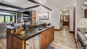 A modern kitchen with granite countertops, stainless steel appliances, and wooden cabinetry. - Remodeled 3br Condo In Bachelor Gulch - Ski In/out 3 Bedroom Condo (Avon)