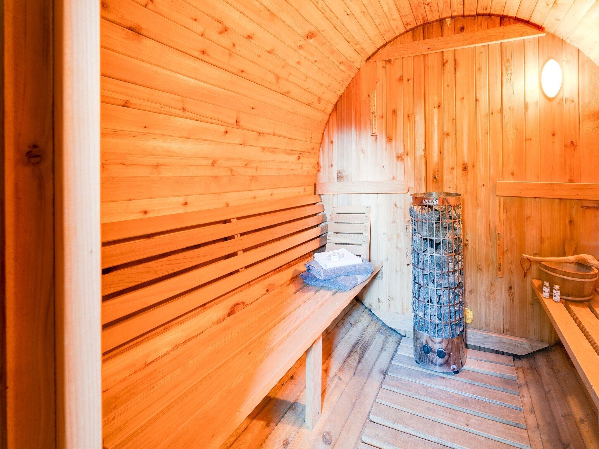 A sauna room with wooden walls and benches.