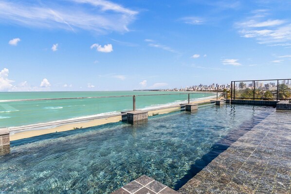 Outdoor pool, open 6:00 AM to 10:00 PM, pool umbrellas, sun loungers