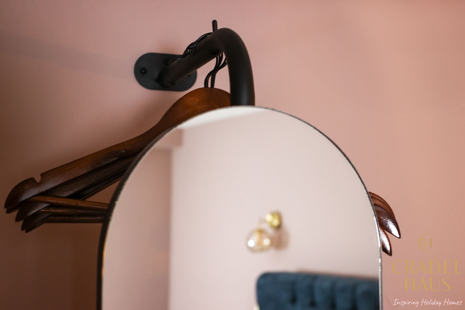 A close-up of a white, curved object with a black handle and a small pearl-like detail.