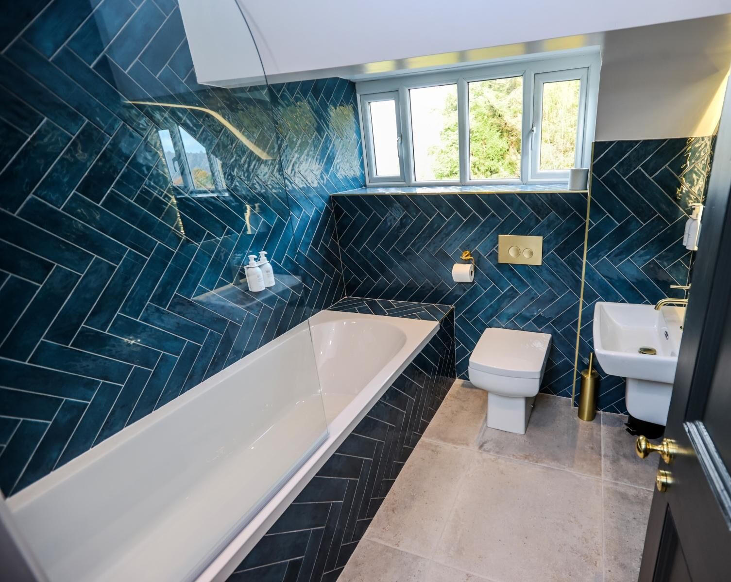 A modern bathroom with a freestanding bathtub, a toilet, and a sink.