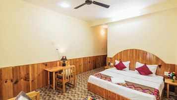 Cozy retreat with a comfortable bed, desk, and chair, perfect for working or relaxing.