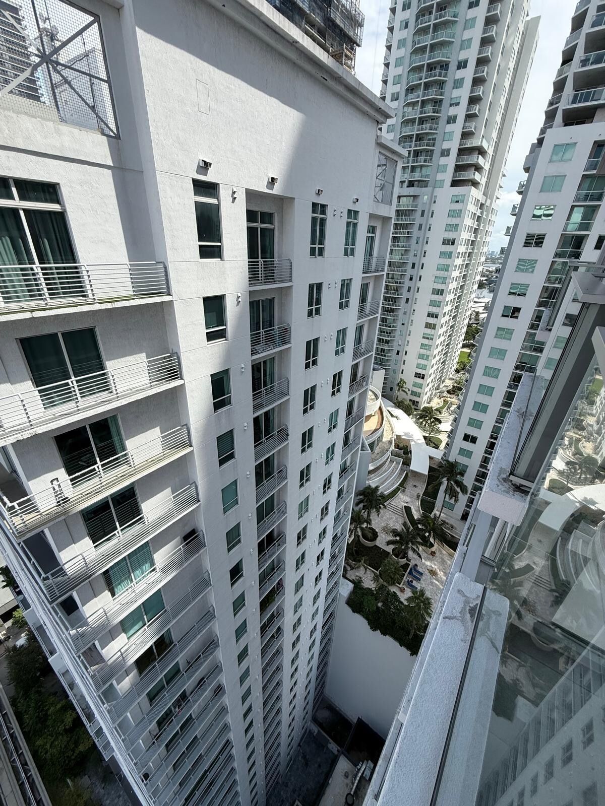 A high-rise building with multiple balconies and a modern architectural design.