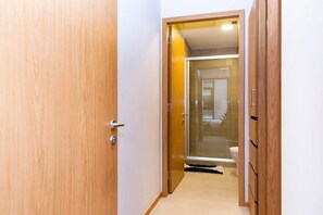 bathroom with a glass shower door and toilet.