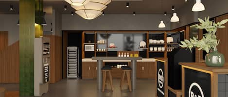 A modern kitchen with a central island, wooden cabinets, and a B&B hotel sign.